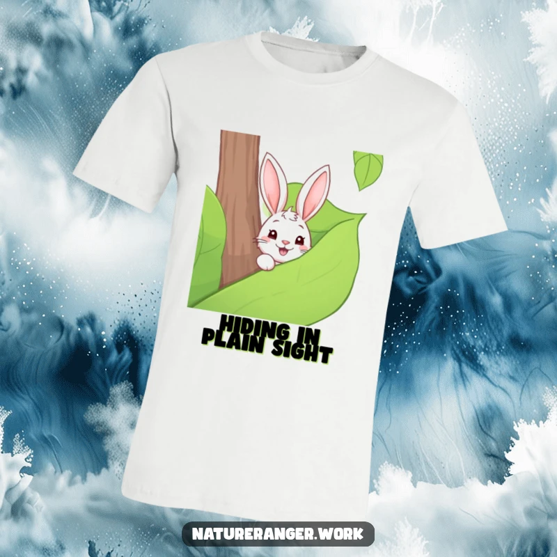 Funny t-shirt design of a playful cartoon rabbit peeking from behind a large green forest leaf with curious eyes.
